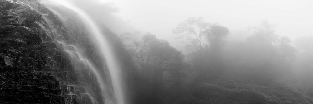 Black and white panorama of the Love Waterfall on a misty day in Sapa, Vietnam