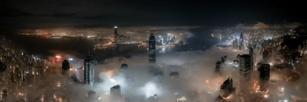 Aerial panorama print of the Hong Kong skyline lost amongst a sea of low clouds at night